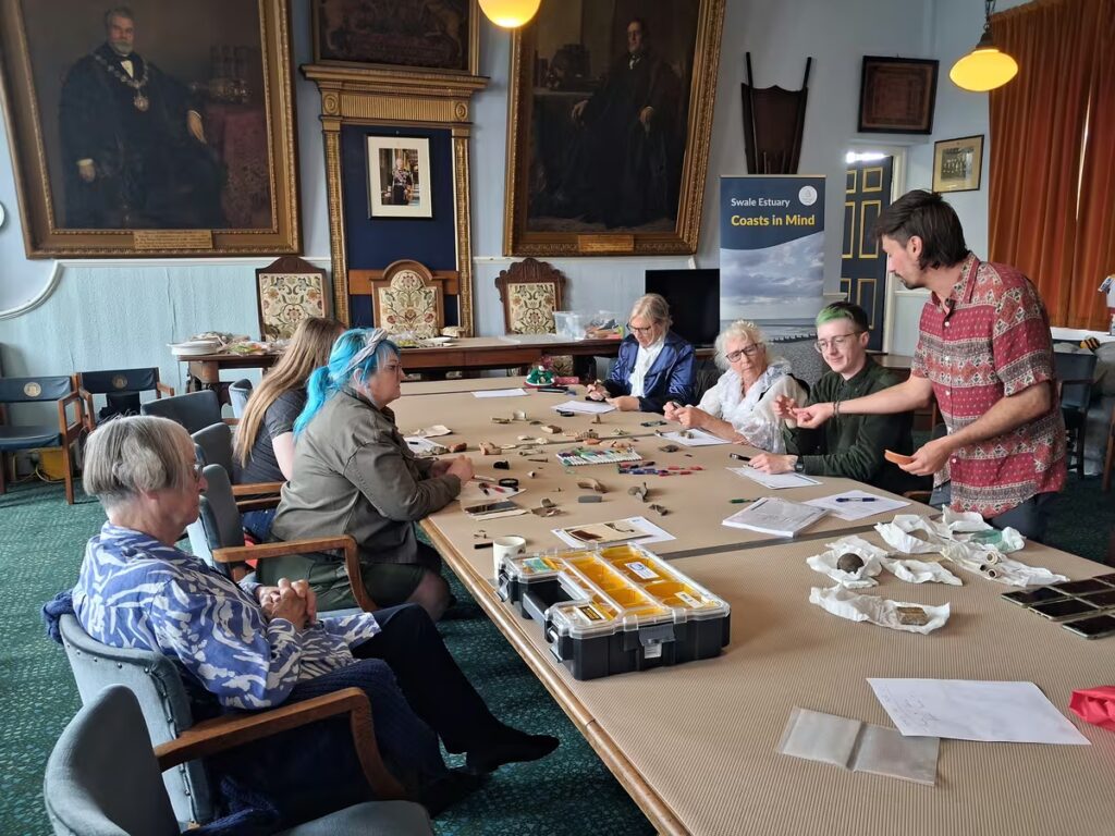 Participants learning how to identify and record foreshore finds with archaeologist Harry Farmer. (Copyright: CiM/MOLA)